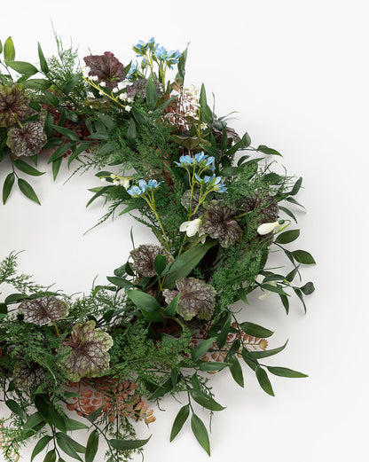 Couronne de fougères artificielles et de bégonias